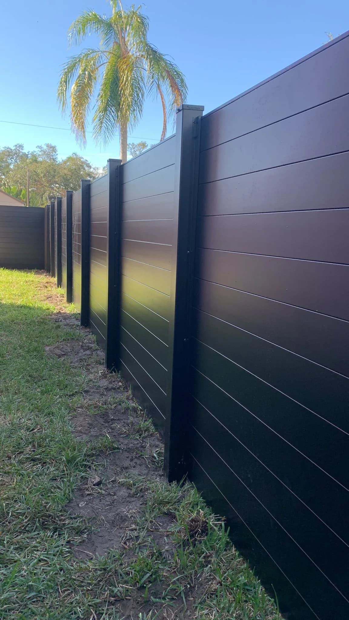 Black metal privacy fence installation
