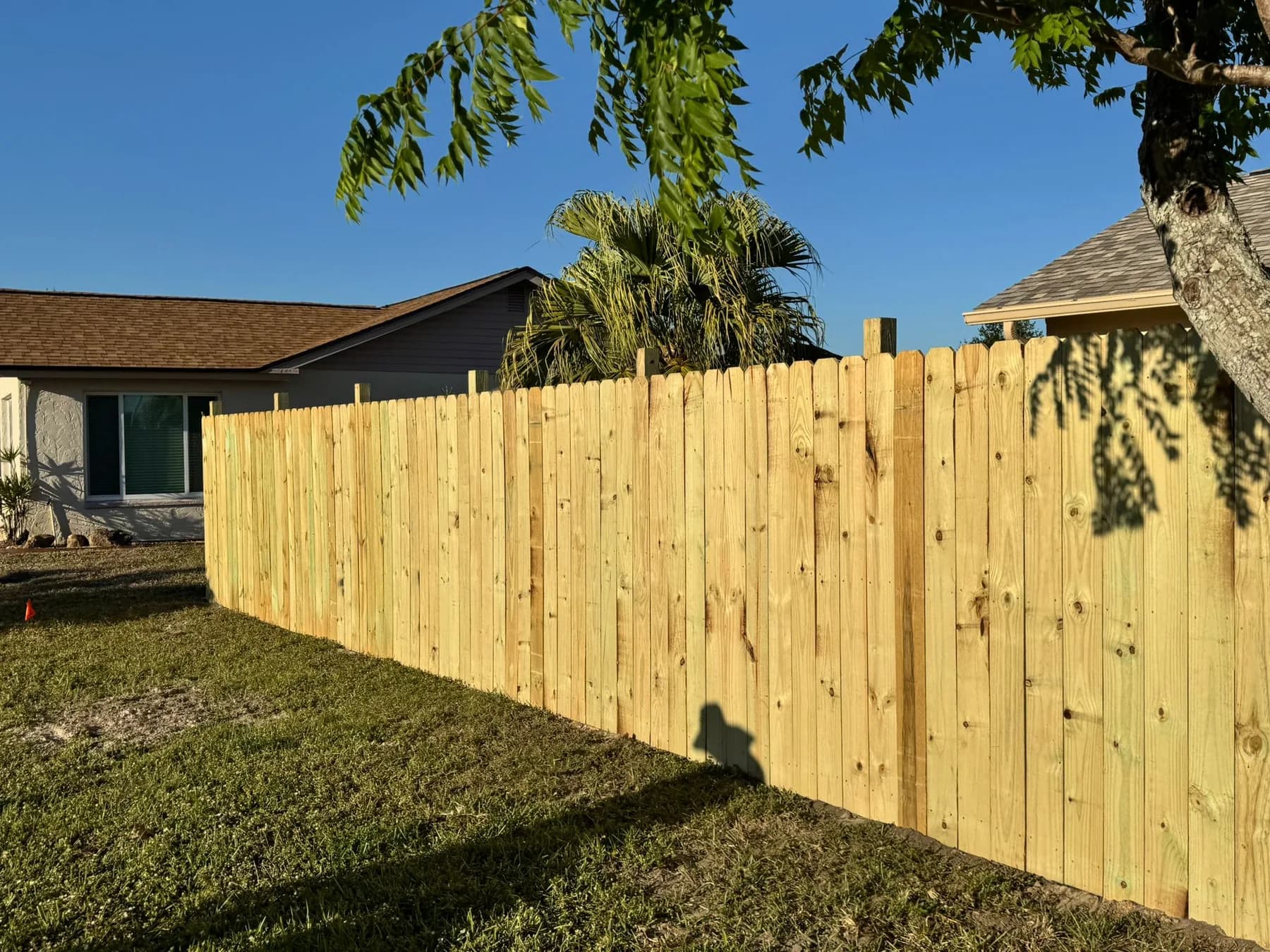 Fresh wood privacy fence installation